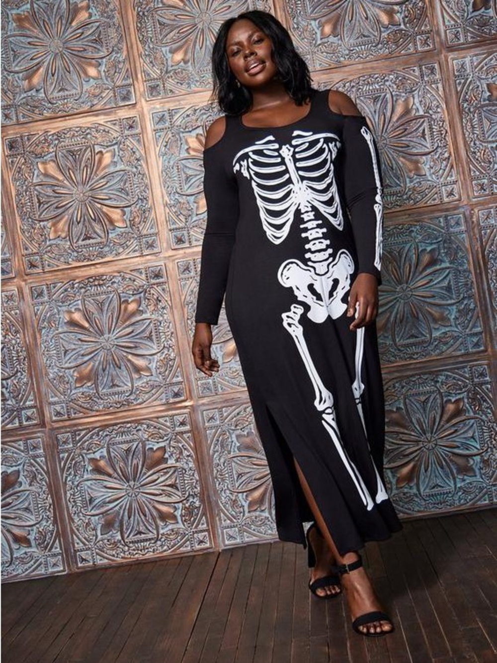 Torrid white skeleton print on black maxi dress with shoulder cutouts.